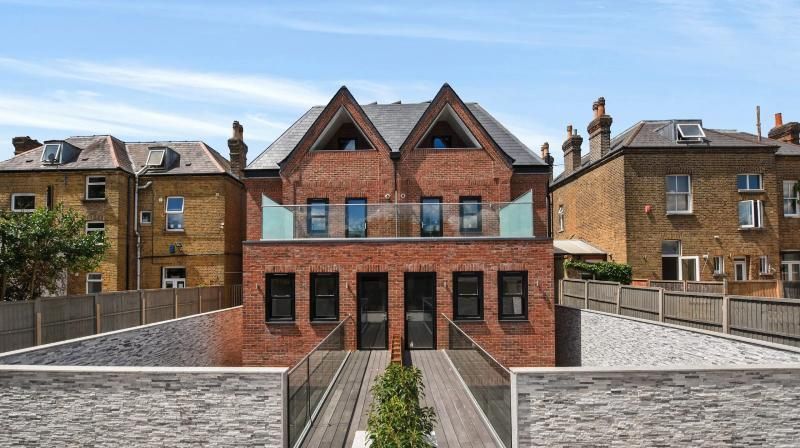 Pair of new-build brick houses with glass balconies