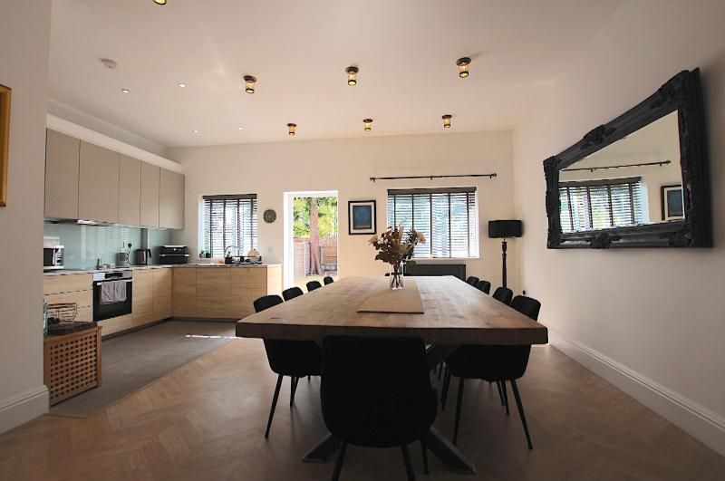 Kitchen and dining room with a long oak table